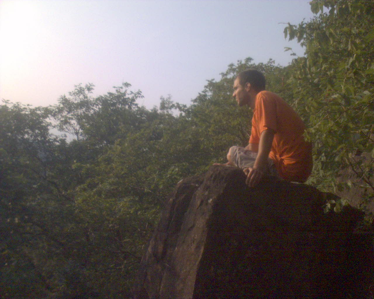 Adam sitting on a cliffs edge on the Mattabasset Trail in Central Connecticut.